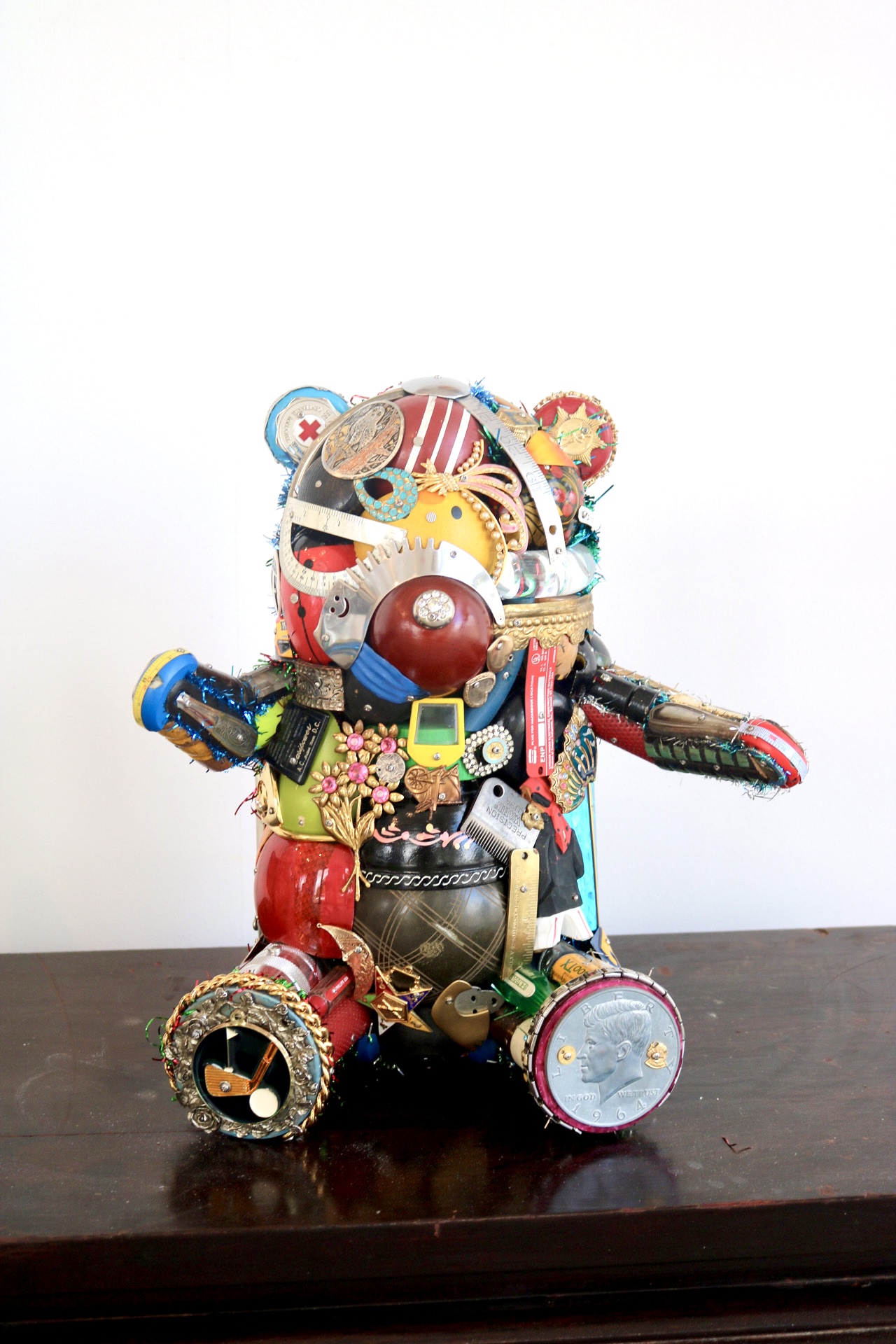 A standing bear sculpture built from hundreds of found metal, wood, and plastic objects by Leo Sewell